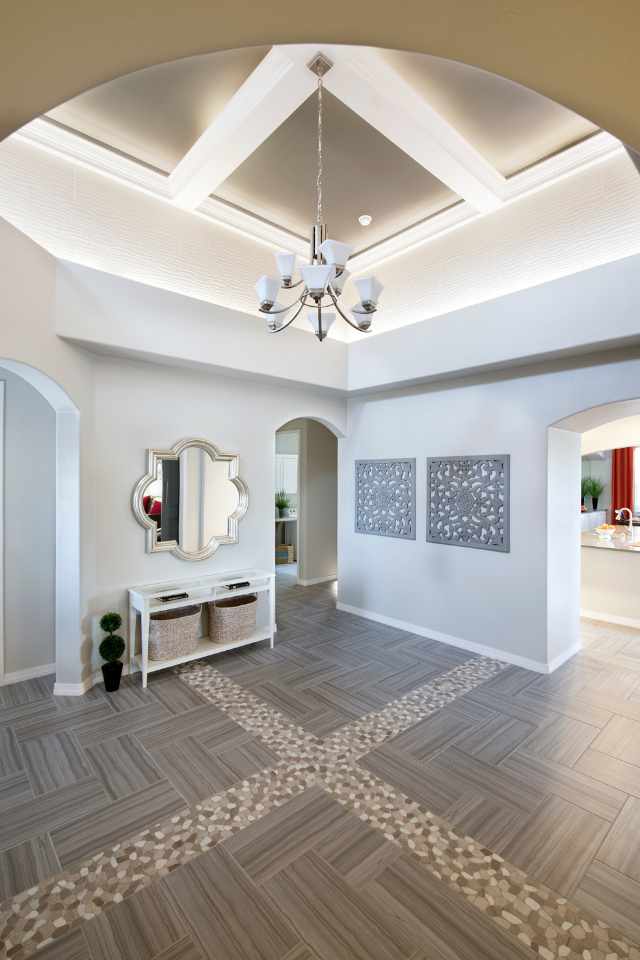 natural stone pebbles inlaid in natural stone tile floor of grand foyer